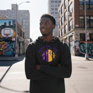 Young man in a black hoodie stands confidently on a city street.