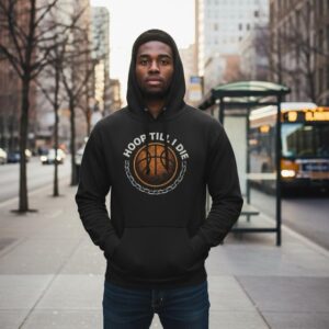 A young man in a black hoodie stands on a city street with a bus in the background.
