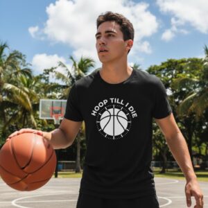 Young man holding basketball and glass outdoors.
