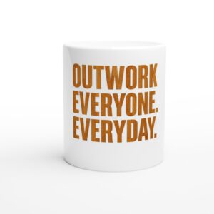 White mug with bold orange motivational text.
